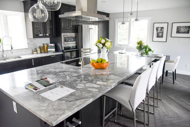 Mid-sized minimalist galley vinyl floor eat-in kitchen photo in Edmonton with shaker cabinets, brown cabinets, granite countertops, stainless steel appliances and an island