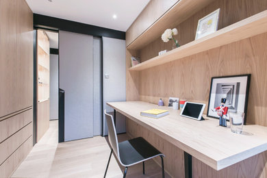 Example of a mid-sized trendy built-in desk light wood floor and beige floor study room design in Hong Kong with gray walls
