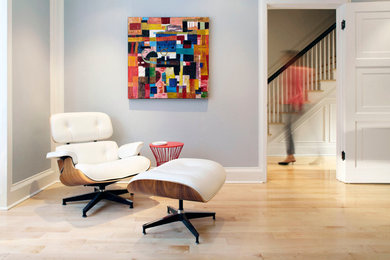 Example of a large trendy enclosed light wood floor and beige floor living room design in Toronto with gray walls, a standard fireplace, a tile fireplace and a wall-mounted tv