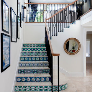 This is an example of a medium sized mediterranean tiled l-shaped staircase in Tampa with tiled risers.