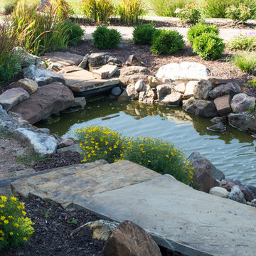 Rustic Mountain stream flowing into lakeside patio