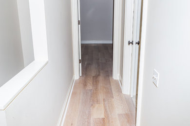 Inspiration for a mid-sized timeless light wood floor and beige floor hallway remodel in Chicago with beige walls