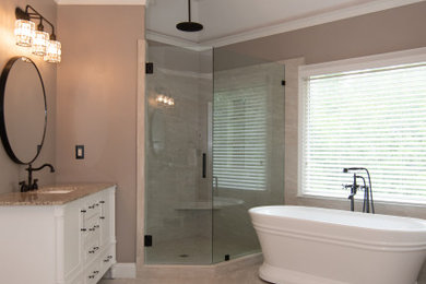 Example of a classic single-sink bathroom design in Atlanta with furniture-like cabinets, white cabinets, brown walls, granite countertops, a hinged shower door and a freestanding vanity