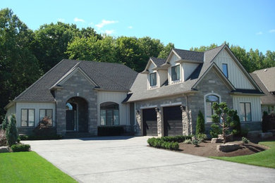 Inspiration for a large transitional gray one-story stone exterior home remodel in Toronto with a shed roof