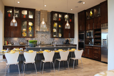 Open concept kitchen - large modern l-shaped ceramic tile open concept kitchen idea in Austin with an undermount sink, flat-panel cabinets, dark wood cabinets, quartz countertops, multicolored backsplash, mosaic tile backsplash, stainless steel appliances and an island
