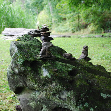 Meditative stone stacking on boulder.