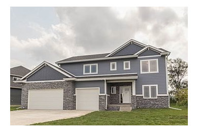 Inspiration for a large transitional blue two-story concrete fiberboard gable roof remodel in Other