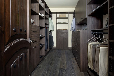 Mid-sized contemporary men's walk-in wardrobe in San Francisco with flat-panel cabinets, dark wood cabinets, dark hardwood floors and brown floor.