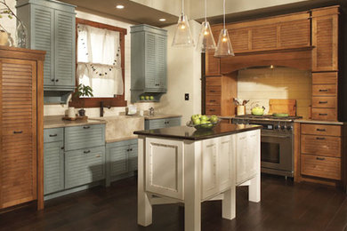 Small farmhouse l-shaped dark wood floor eat-in kitchen photo in Sacramento with louvered cabinets, medium tone wood cabinets, solid surface countertops, beige backsplash, wood backsplash, stainless steel appliances and an island