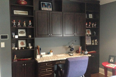 Example of a mid-sized classic built-in desk medium tone wood floor and brown floor home office design in Philadelphia with gray walls