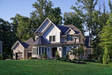 Inspiration for a large transitional gray three-story stucco exterior home remodel in DC Metro with a shingle roof and a gray roof
