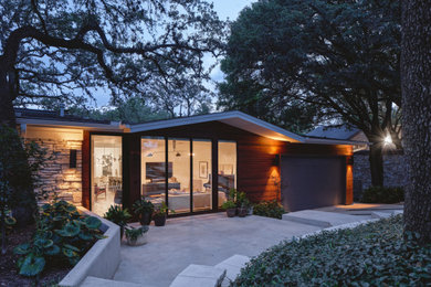 Design ideas for a small modern house exterior in Austin with wood siding.