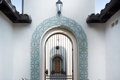 Large mediterranean white one-story stucco exterior home idea in San Diego