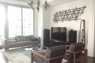 Small minimalist open concept dark wood floor living room photo in Toronto with white walls and a tv stand