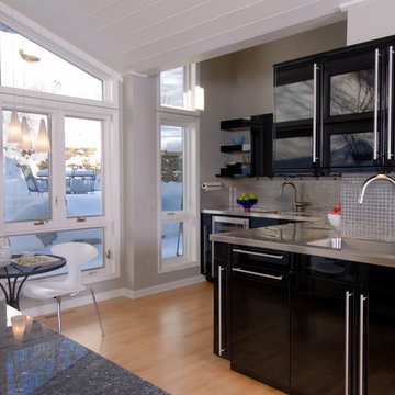 Sleek Contemporary Kitchen High Gloss Black Cabinets and Oversized Hardware