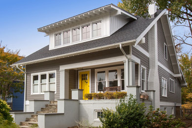 Example of an arts and crafts gray three-story concrete fiberboard house exterior design in DC Metro with a shingle roof