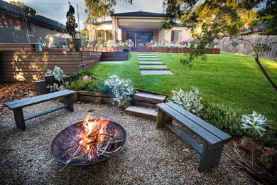 Mid-sized modern backyard garden in Melbourne with a fire feature and decking.