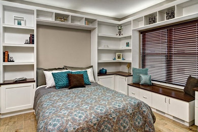 Inspiration for a large contemporary light wood floor and brown floor bedroom remodel in Minneapolis with beige walls and no fireplace