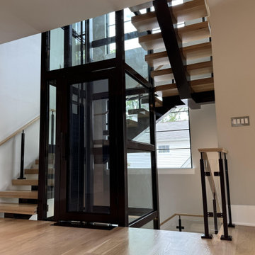 Project #136 | Modern Floating Staircase Encircling Glass Elevator