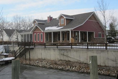 Example of a mid-sized red two-story mixed siding exterior home design in Omaha