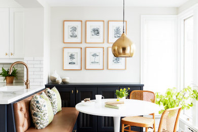 Example of a transitional multicolored floor kitchen/dining room combo design in Toronto with white walls and no fireplace