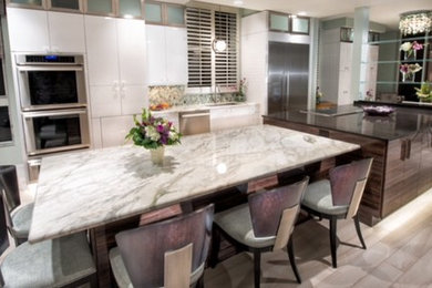 Large transitional single-wall eat-in kitchen in Miami with a single-bowl sink, flat-panel cabinets, dark wood cabinets, multi-coloured splashback, stainless steel appliances, light hardwood floors and with island.