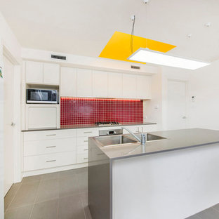 Small contemporary kitchen pantry ideas - Example of a small trendy single-wall kitchen pantry design in Canberra - Queanbeyan with quartz countertops and an island
