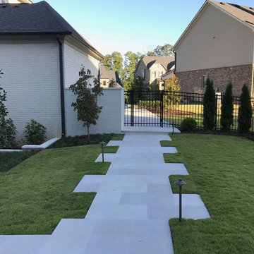 Lighted Limestone paver path from driveway to outdoor oasis
