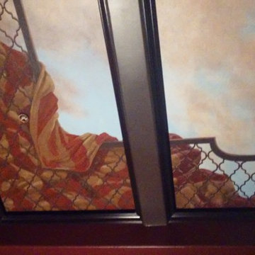Mural of Moroccan sunset on coffered ceiling in home theater