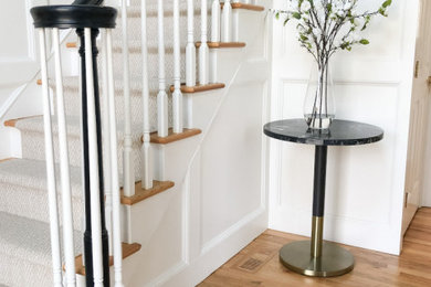 Entry hall - small modern medium tone wood floor and wall paneling entry hall idea in Los Angeles with white walls