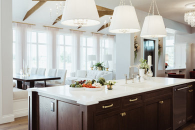 Design ideas for an expansive traditional l-shaped eat-in kitchen in Edmonton with an undermount sink, shaker cabinets, white cabinets, quartz benchtops, white splashback, mosaic tile splashback, stainless steel appliances, medium hardwood floors, with island, brown floor, white benchtop and exposed beam.