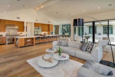 This is an example of a large modern formal open concept living room in San Francisco with white walls, light hardwood floors, no fireplace, no tv and beige floor.