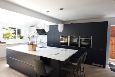 Photo of a large contemporary kitchen in Other with flat-panel cabinets, blue cabinets, quartz worktops and white worktops.