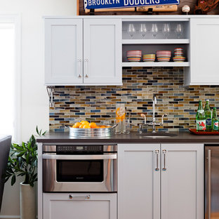 This is an example of a classic basement in Portland with white walls and medium hardwood flooring.