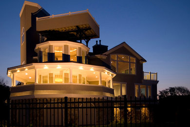 Example of a large trendy beige three-story wood house exterior design in Boston with a hip roof and a shingle roof