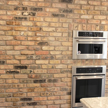 Atkinson, IL- Ranch Home Remodel With Bright White Cabinets and Brick Wall