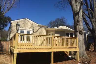 Example of a large trendy backyard deck design in Other
