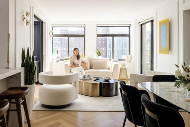 Photo of an open concept living room in New York with light hardwood floors and white walls.