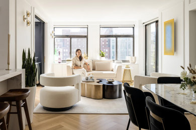 Living room - open concept light wood floor living room idea in New York with white walls
