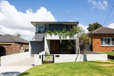 Photo of a large contemporary two-storey concrete house exterior in Sydney.