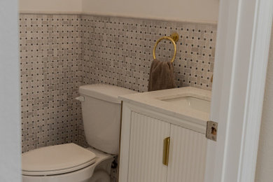 Trendy powder room photo with furniture-like cabinets, white cabinets and a freestanding vanity