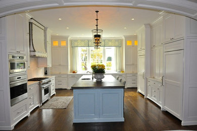 Open concept kitchen - large traditional u-shaped dark wood floor and brown floor open concept kitchen idea in Nashville with recessed-panel cabinets, white cabinets, marble countertops, white backsplash, marble backsplash, paneled appliances and an island