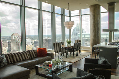 Living room - large contemporary open concept and formal medium tone wood floor living room idea in Austin with gray walls, no fireplace and a wall-mounted tv