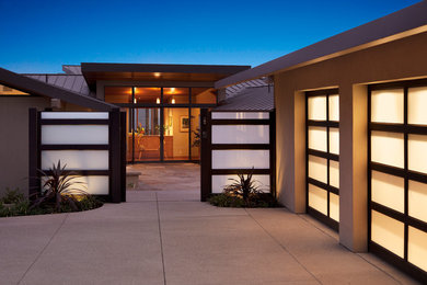 Mid-sized trendy beige one-story stucco exterior home photo in Los Angeles with a metal roof