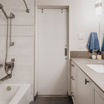 Primary Bathroom with Sliding Door and Porcelain Slab Vanity
