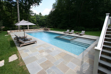 This is an example of a large backyard rectangular pool in New York with a hot tub.