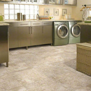 Medium sized traditional l-shaped separated utility room in San Diego with glass-front cabinets, stainless steel cabinets, marble worktops, beige walls, ceramic flooring and a side by side washer and dryer.