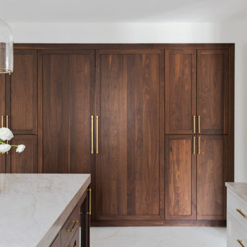 Custom Walnut and White Kitchen Remodel with Marble Slab Backsplash and Brass Ac