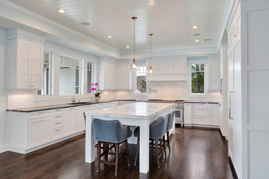 Eat-in kitchen - large transitional u-shaped dark wood floor eat-in kitchen idea in New York with an undermount sink, shaker cabinets, white cabinets, soapstone countertops, white backsplash, subway tile backsplash, paneled appliances and an island