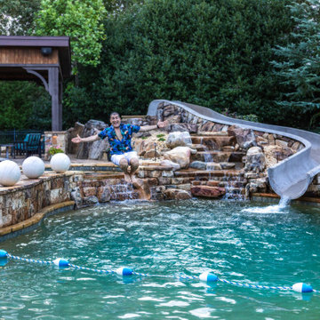 Resort-Style Pool with Rock Waterfall & Custom Waterslide